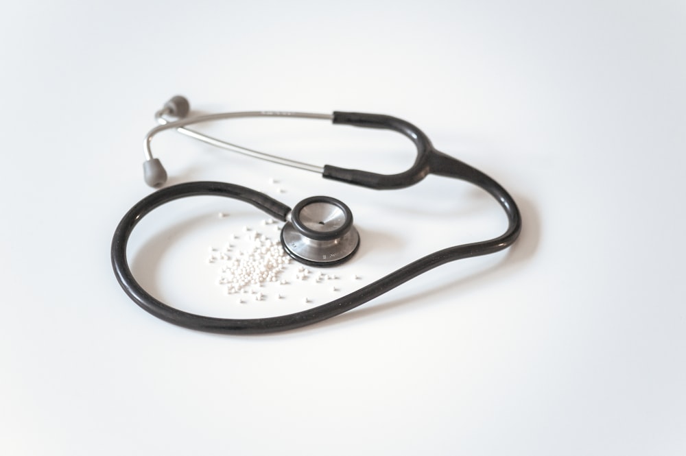 A stethoscope resting on a clean white surface